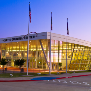 Curtis Culwell Center at dusk with lights on inside the facility